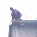Matthew uses a Safety harness while on the roof 